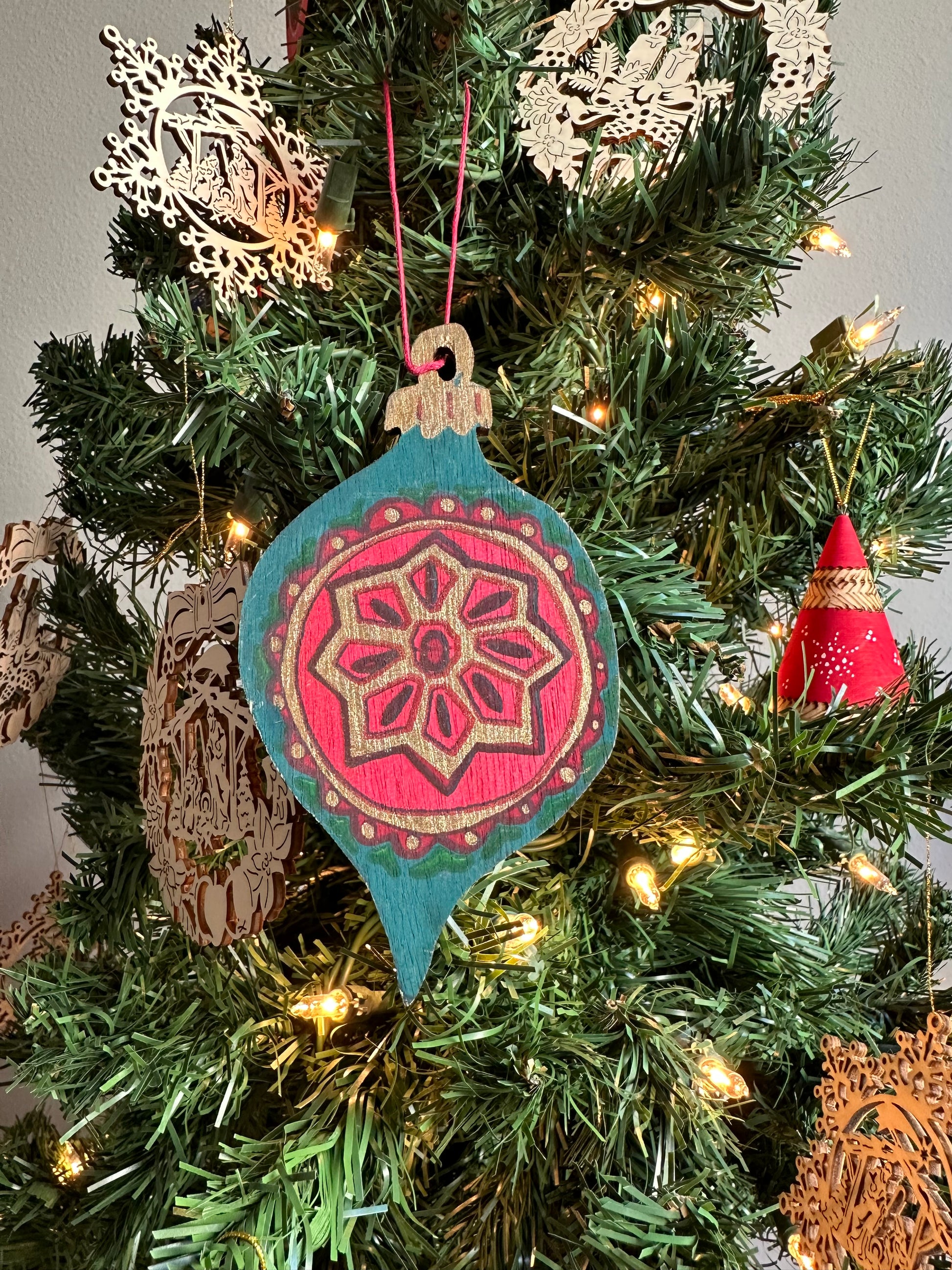 Wooden Bauble Ornament hanging on a Christmas tree.