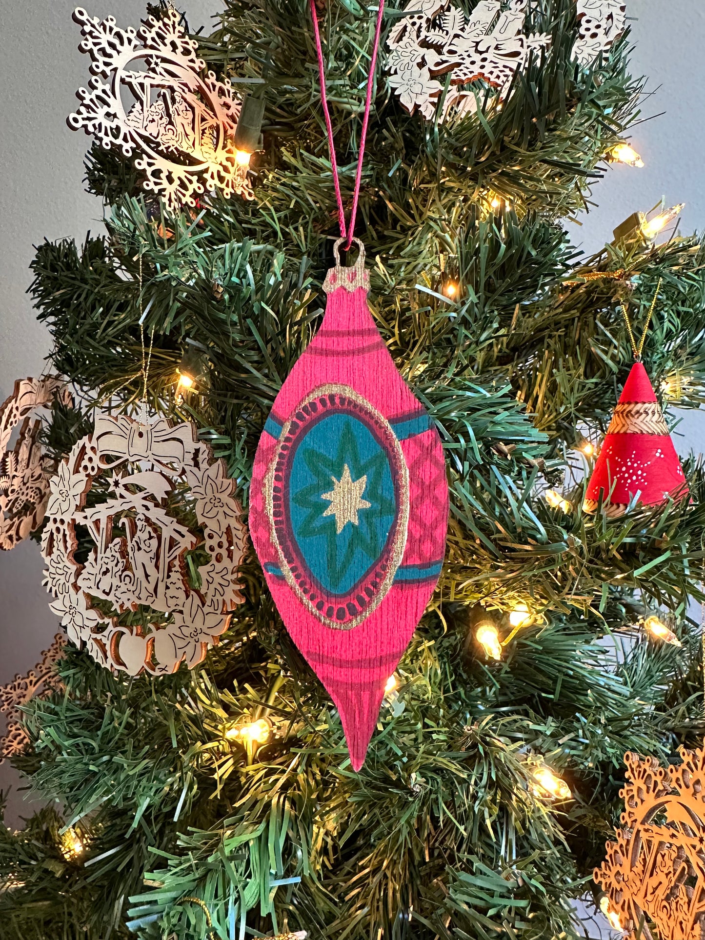 Wooden Bauble Ornament hanging on a Christmas tree.