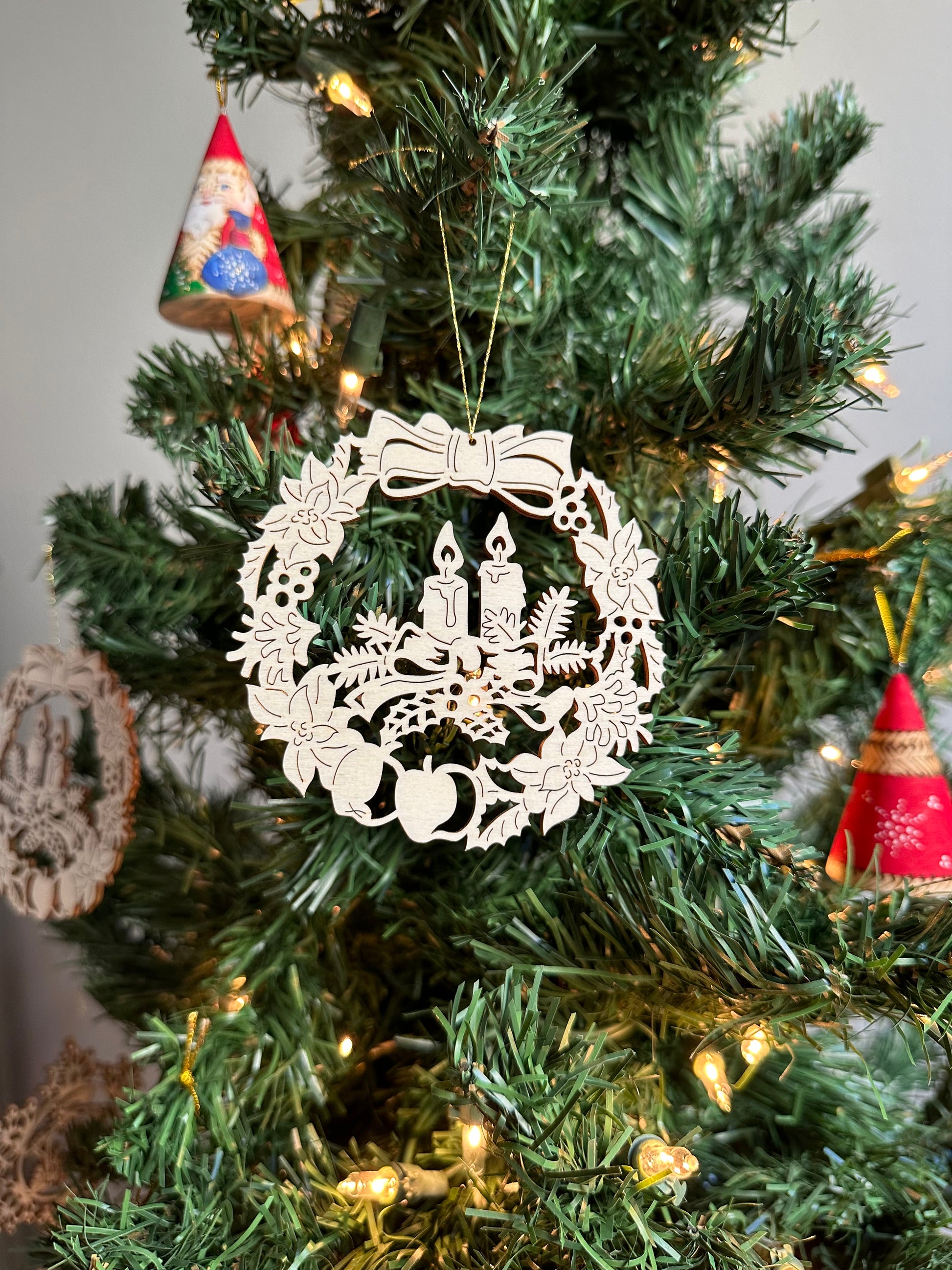 Wooden Christmas Ornament featuring a candle and wreath design.