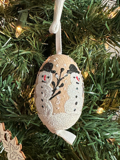 Austrian Christmas Egg Ornament featuring a glittery snowman design, hanging on a tree.