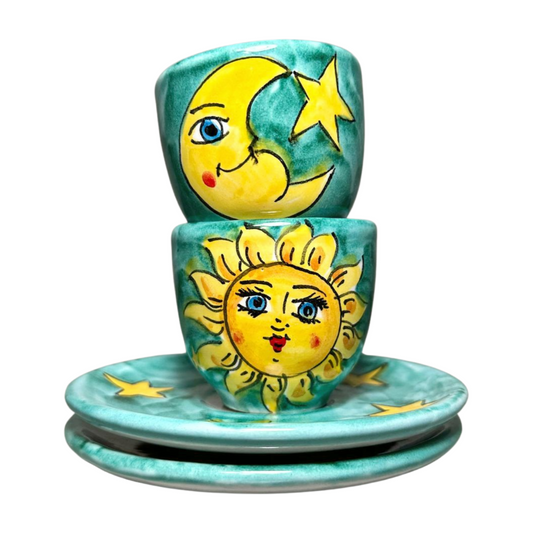Set of 2 Italian espresso cups with matching saucers featuring a celestial sun and moon design. Seen here stacked.