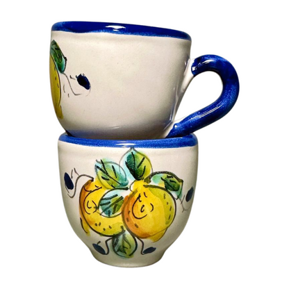 Italian espresso cups featuring a yellow lemon design with a blue rim and handle. Stacked on top of one another.