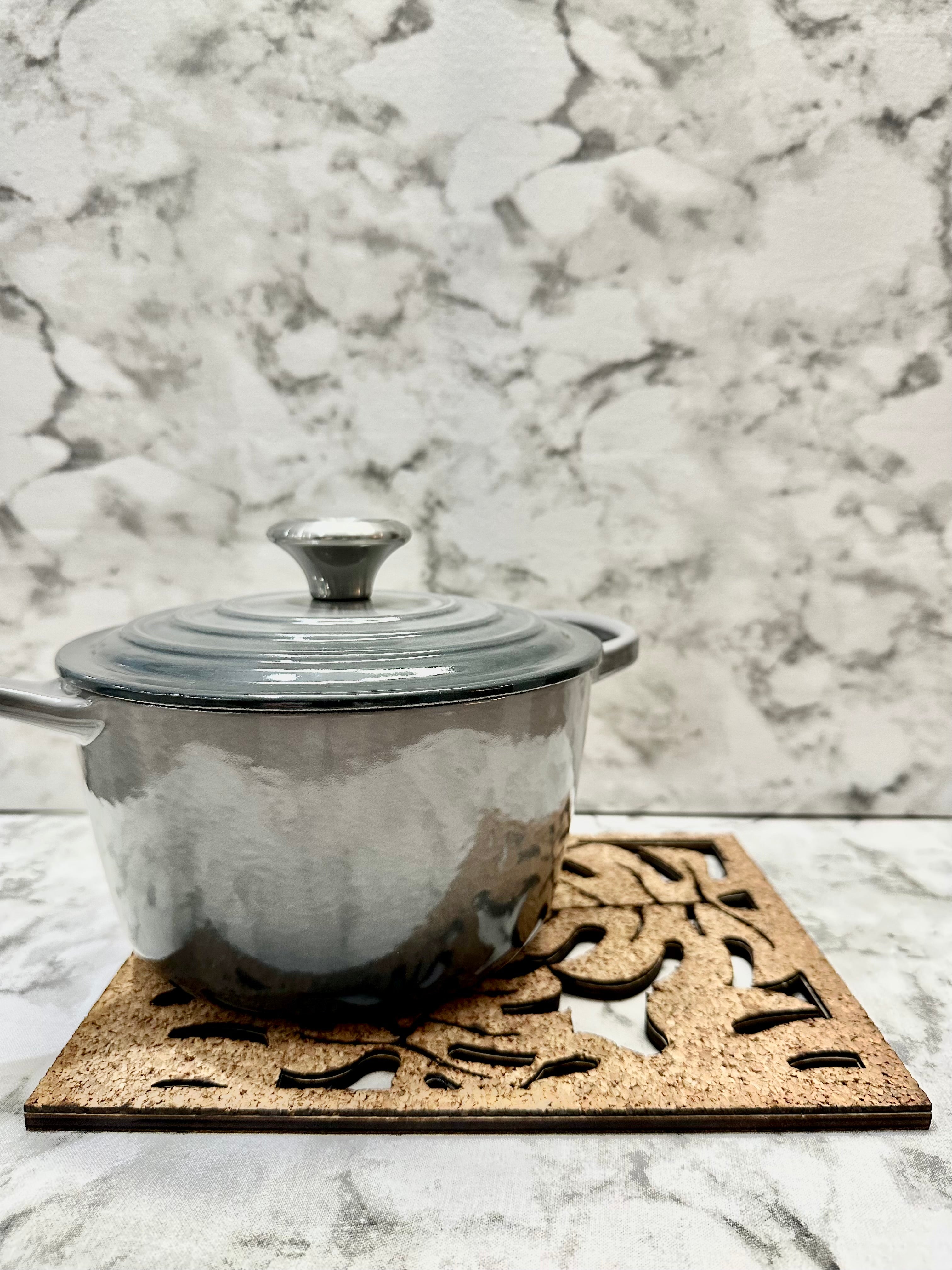 Monstera Leaf Cork Trivet, shown here with a small grey saucepan.