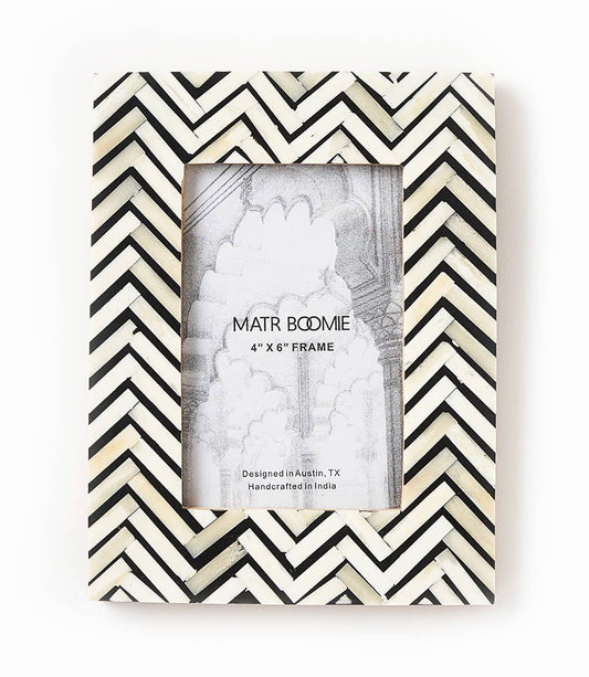 Featuring a modern and bold herringbone patterned tile design, this picture frame will perfectly showcase 4x6 photos. The bone inlay tiles are ethically sourced and in various shades of black and white.