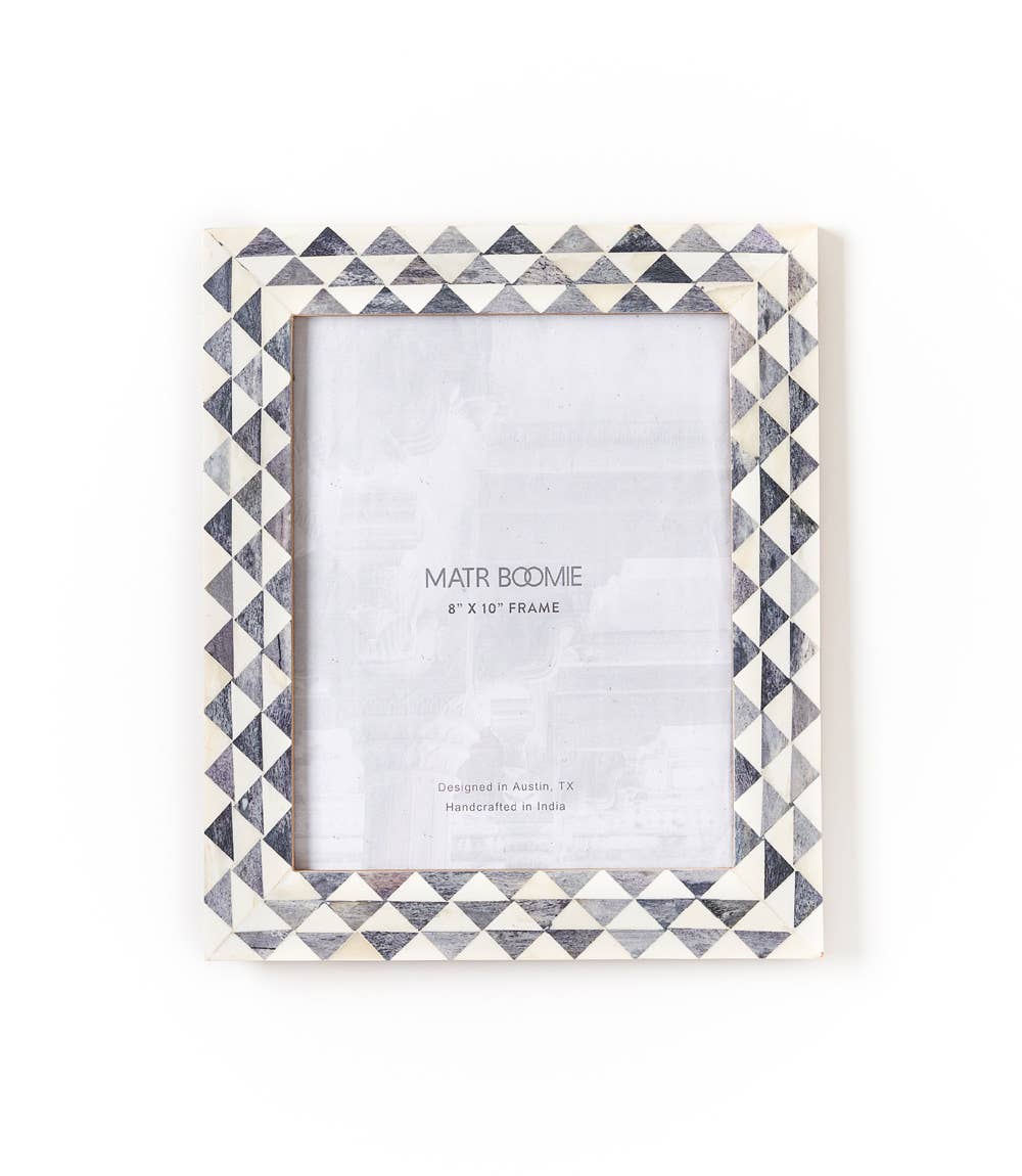 Featuring a modern geometric triangle-patterned tile design, this picture frame will perfectly showcase 8x10 photos. The bone inlay tiles are ethically sourced and in various shades of ivory and grey.