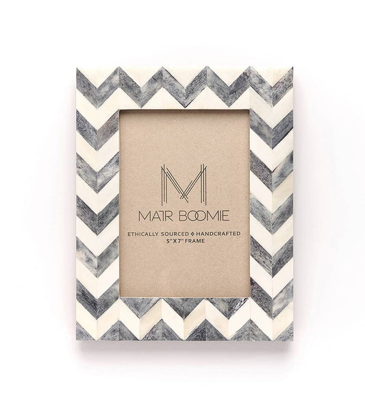 Featuring a modern and bold chevron patterned tile design, this picture frame will perfectly showcase 5x7 photos. The bone inlay tiles are ethically sourced and in various shades of ivory and grey.