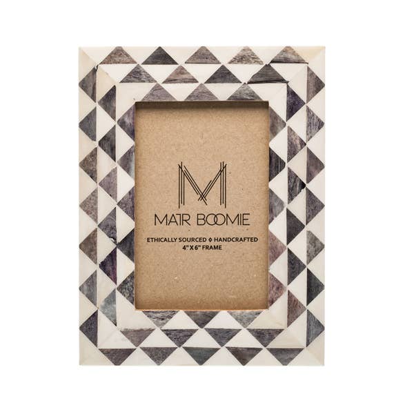Featuring a modern geometric triangle-patterned tile design, this picture frame will perfectly showcase 4x6 photos. The bone inlay tiles are ethically sourced and in various shades of ivory and grey.