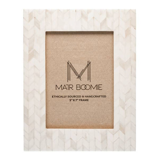 Featuring a modern and elegant chevron-patterned tile design, this picture frame will perfectly showcase 5x7 photos. The bone inlay tiles are ethically sourced and in various shades of ivory.